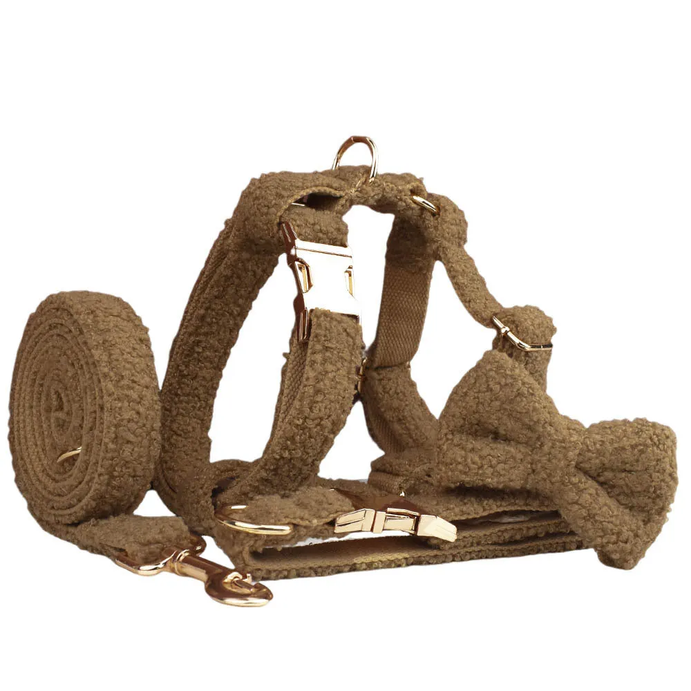 Brown polyester dog necklet set with collar, leash, bow, and vest on a hand-holding rope