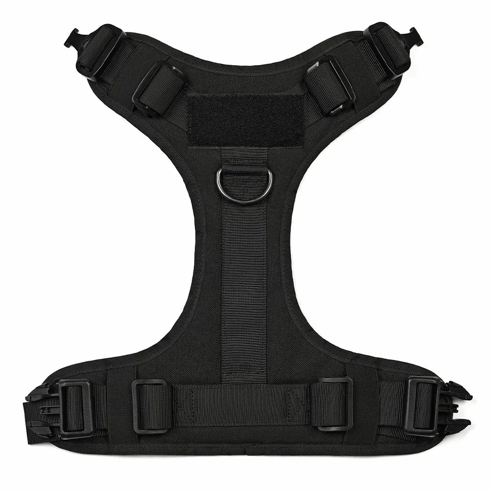 Military tactical dog harness in khaki with adjustable straps, pockets, and metal connection points on a German Shepherd