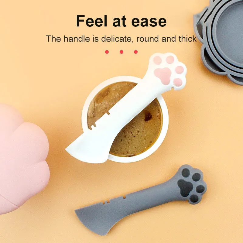 Multifunction silicone pet food spoon and can opener with pink lid, 5.1 inches long, paw-shaped scoop, white background