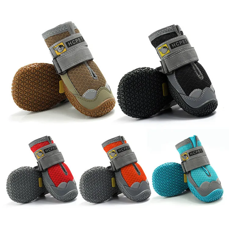 Pair of summer breathable pet dog shoes with non-slip rubber sole in gray black colour on outdoor surface