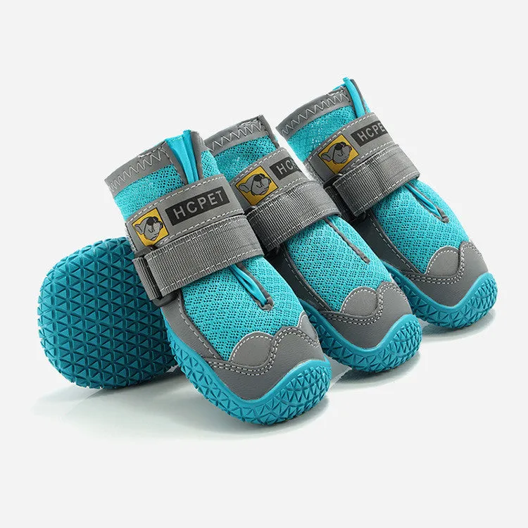 Pair of summer breathable pet dog shoes with non-slip rubber sole in gray black colour on outdoor surface