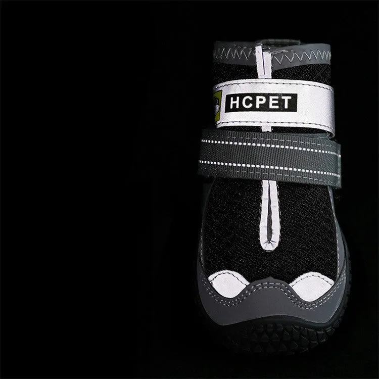 Pair of summer breathable pet dog shoes with non-slip rubber sole in gray black colour on outdoor surface