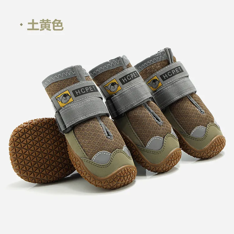 Pair of summer breathable pet dog shoes with non-slip rubber sole in gray black colour on outdoor surface