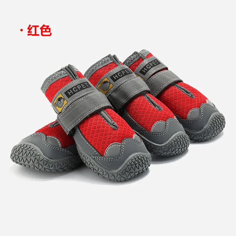 Pair of summer breathable pet dog shoes with non-slip rubber sole in gray black colour on outdoor surface