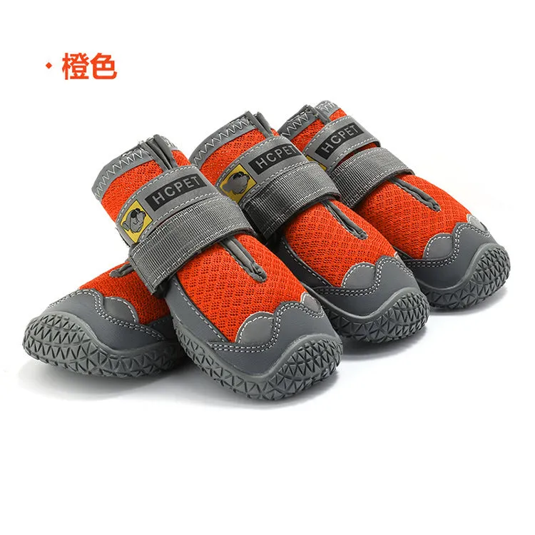 Pair of summer breathable pet dog shoes with non-slip rubber sole in gray black colour on outdoor surface