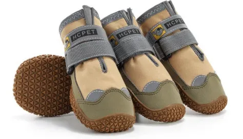 Pair of summer breathable pet dog shoes with non-slip rubber sole in gray black colour on outdoor surface
