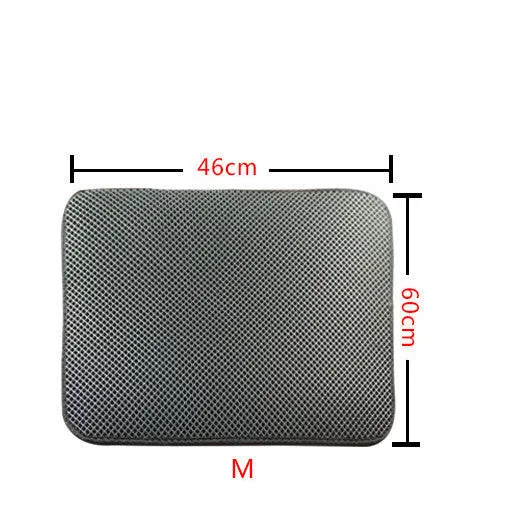 Double layer EVA cat litter mat in black with textured surface, placed under a litter box to trap debris