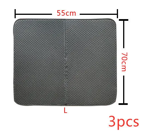 Double layer EVA cat litter mat in black with textured surface, placed under a litter box to trap debris