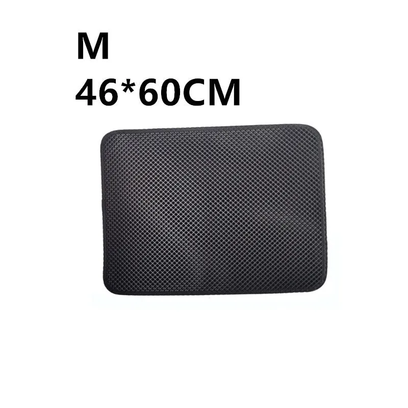 Double layer EVA cat litter mat in black with textured surface, placed under a litter box to trap debris