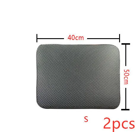 Double layer EVA cat litter mat in black with textured surface, placed under a litter box to trap debris