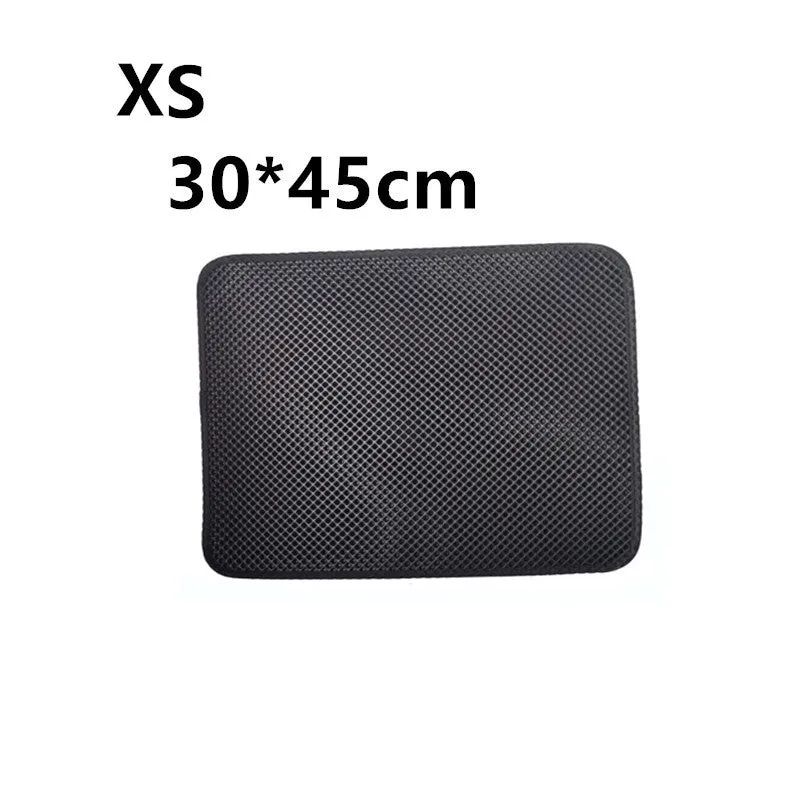 Double layer EVA cat litter mat in black with textured surface, placed under a litter box to trap debris