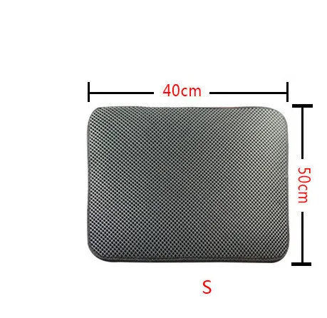 Double layer EVA cat litter mat in black with textured surface, placed under a litter box to trap debris