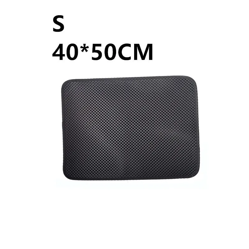 Double layer EVA cat litter mat in black with textured surface, placed under a litter box to trap debris