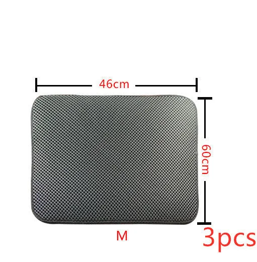 Double layer EVA cat litter mat in black with textured surface, placed under a litter box to trap debris
