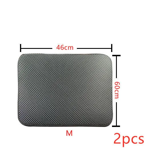 Double layer EVA cat litter mat in black with textured surface, placed under a litter box to trap debris