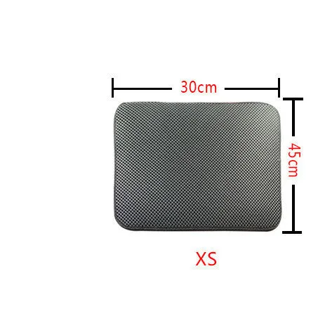 Double layer EVA cat litter mat in black with textured surface, placed under a litter box to trap debris