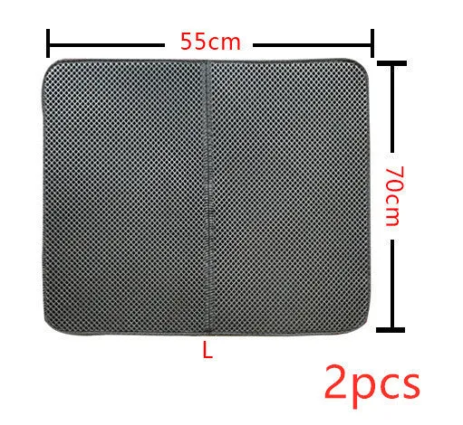 Double layer EVA cat litter mat in black with textured surface, placed under a litter box to trap debris