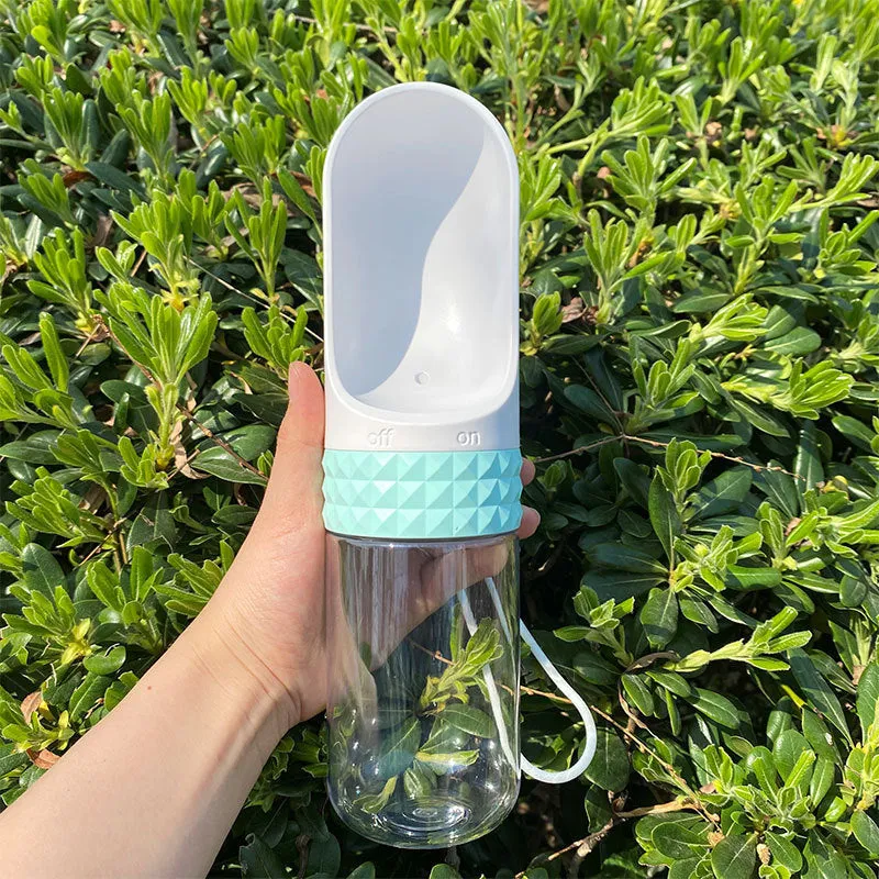 Portable dog water cup with one-click lock, food-grade ABS construction, available in various colours for outdoor pet hydration