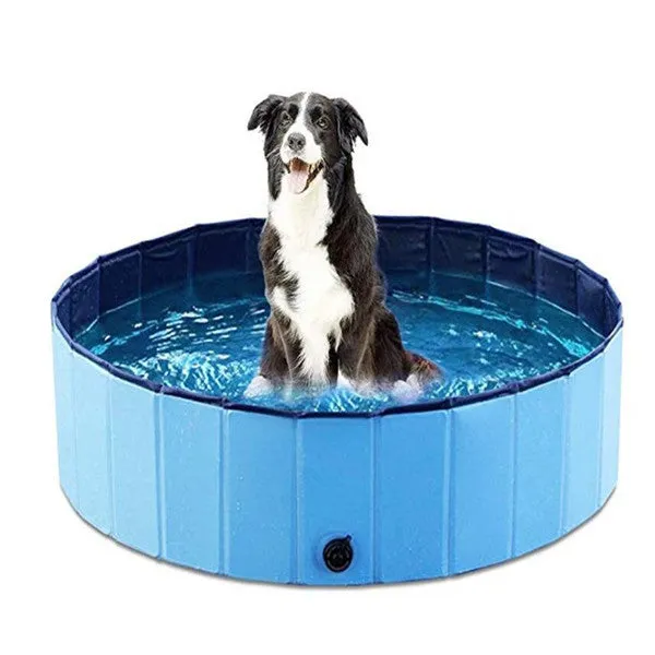 Foldable blue dog swimming pool with thickened PVC material and quick drain valve, set up on grass