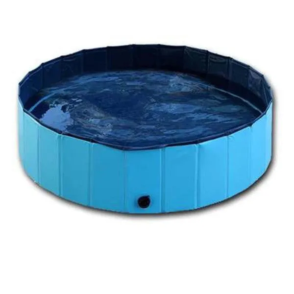 Foldable blue dog swimming pool with thickened PVC material and quick drain valve, set up on grass