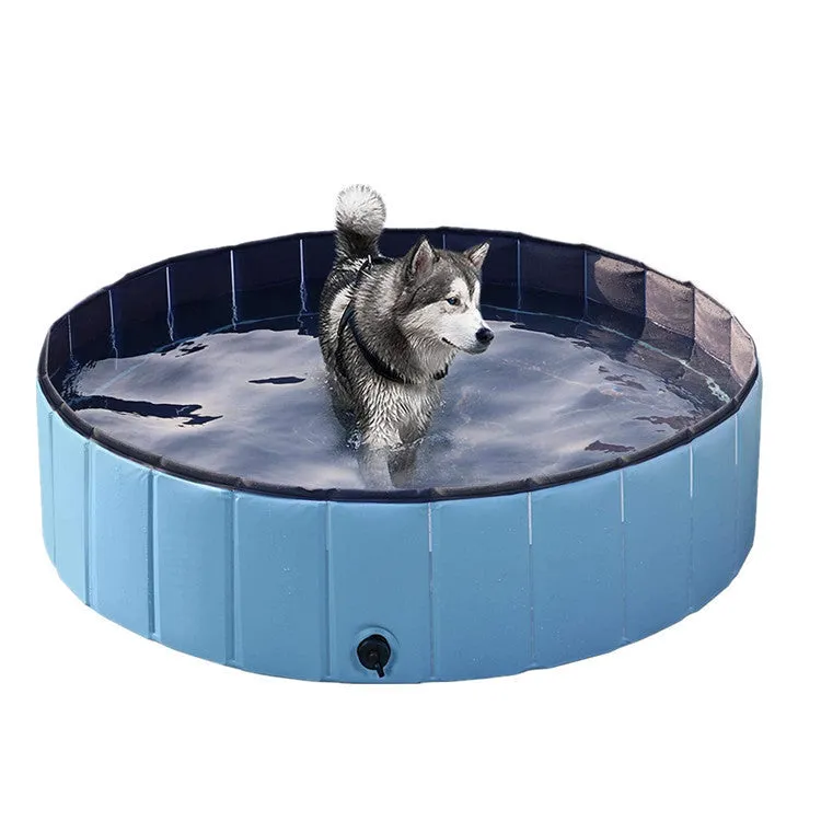 Foldable blue dog swimming pool with thickened PVC material and quick drain valve, set up on grass