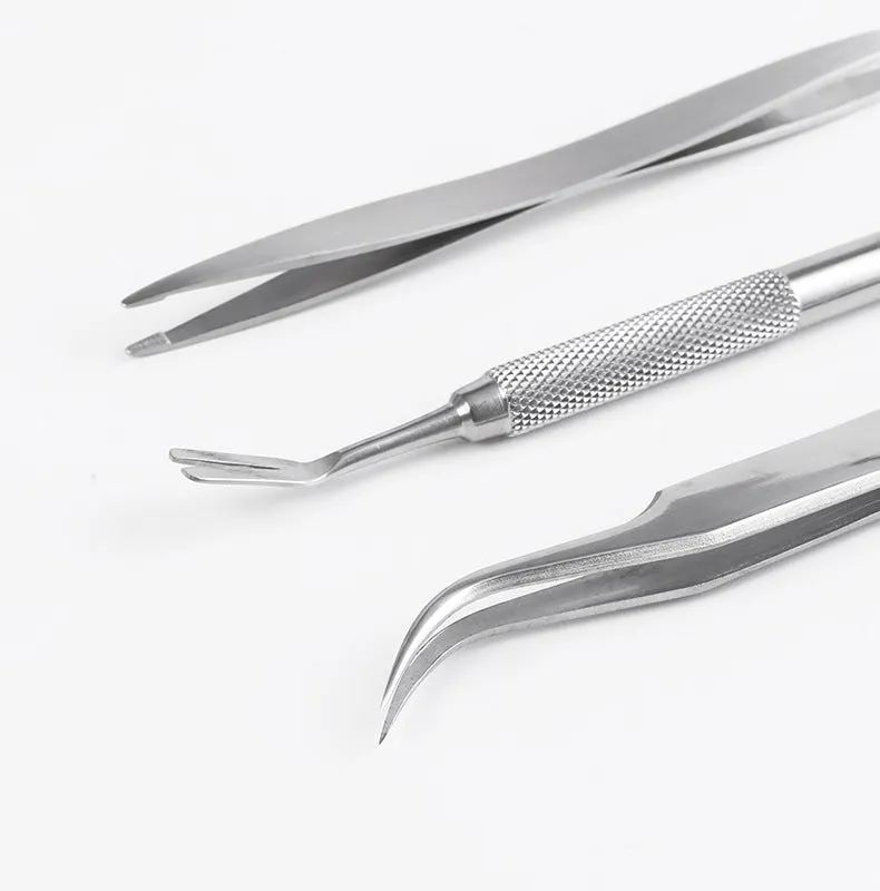 Three silver stainless steel tick clips with grate-style heads for pet parasite removal