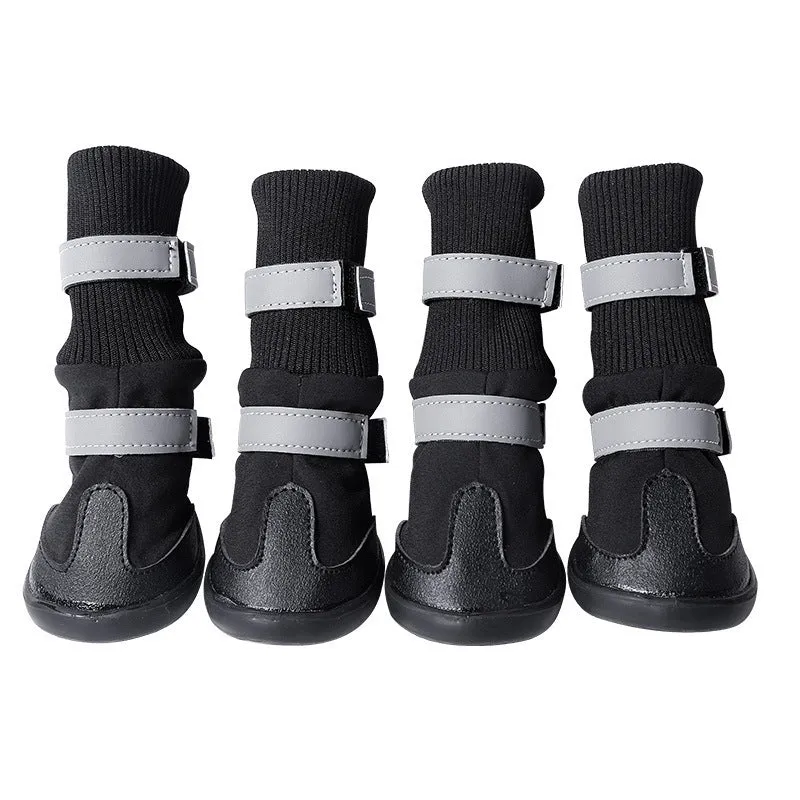 Pair of black wear-resistant waterproof snow boots with non-slip sole on snowy ground