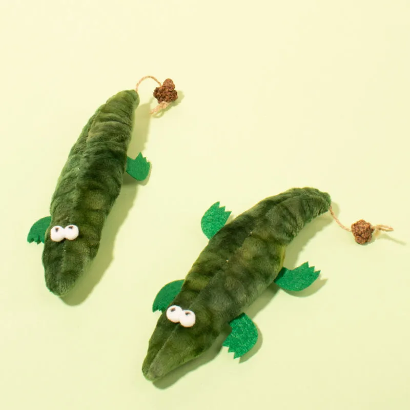 Green plush alligator catnip toy with peppermint scent for oral cleansing and stress relief