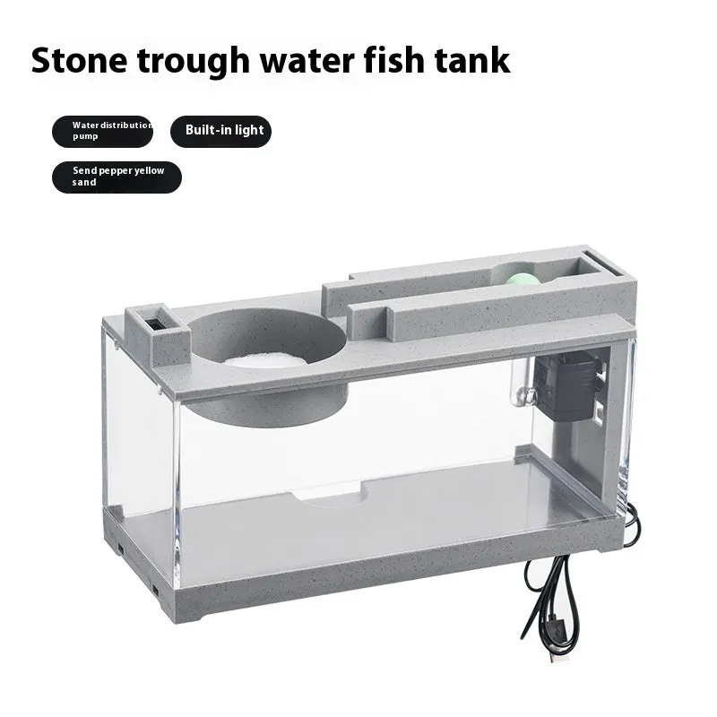 Small stone trough plastic fish tank with water pump and built-in light on a desk