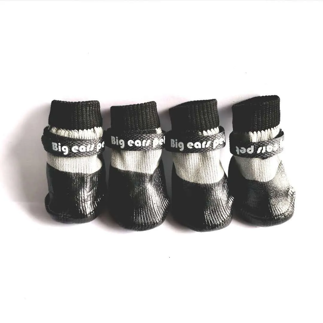 Pet dog soft bottom anti-scratch shoe cover in black on a light-coloured floor showing non-slip sole
