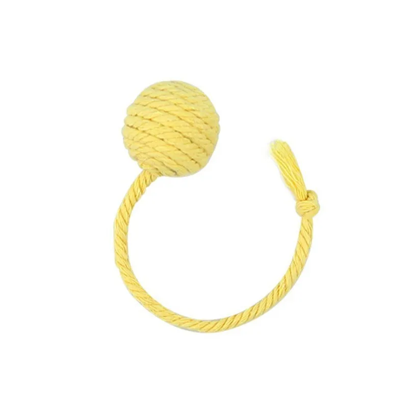 Colourful cat toy ball with attached rope and internal bell, shown in green, pink, purple, and yellow variants.