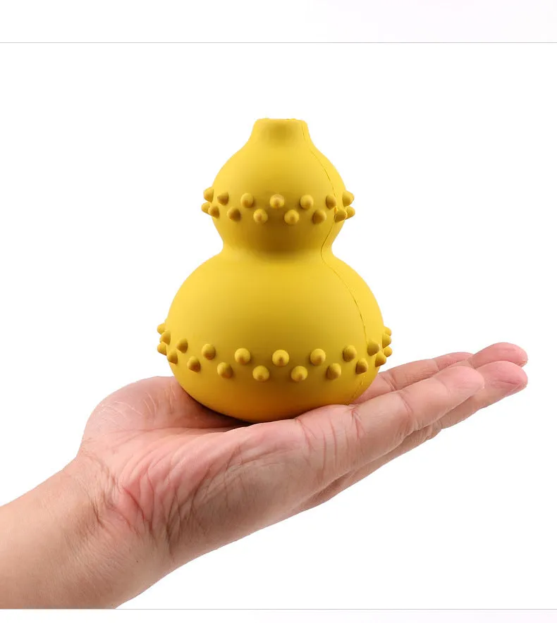 Natural rubber pet toy resistant to biting and grinding, treat dispensing ball in red, 11.3 by 8.5 cm