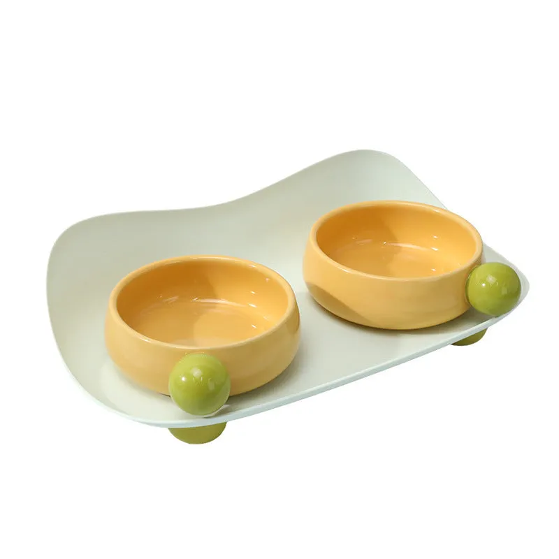 Ceramic pet feeding bowl set with two raised bowls and non-slip base in pink colour