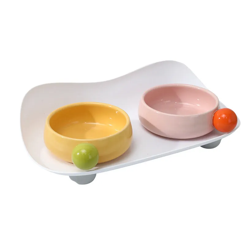 Ceramic pet feeding bowl set with two raised bowls and non-slip base in pink colour