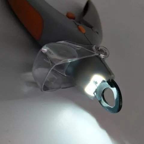 Yellow and grey pet nail trimmer clipper with LED light and magnifying glass on white background
