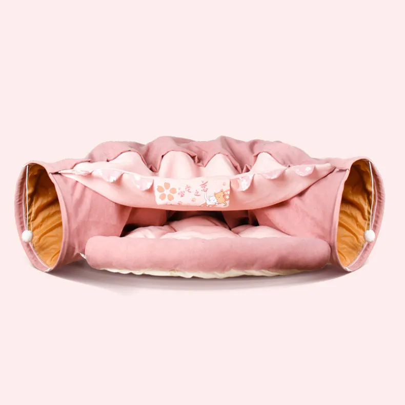 Collapsible cloth cat tunnel in Pink colour with visible opening, measuring 45x50x22 cm, on wooden floor