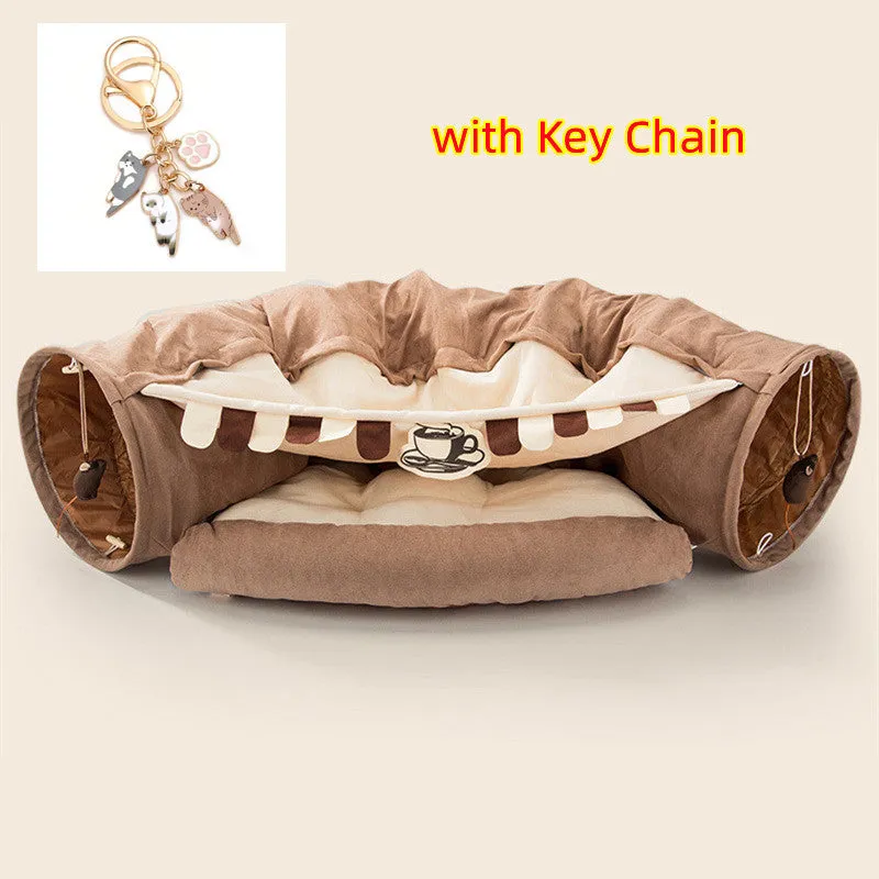 Collapsible cloth cat tunnel in Pink colour with visible opening, measuring 45x50x22 cm, on wooden floor