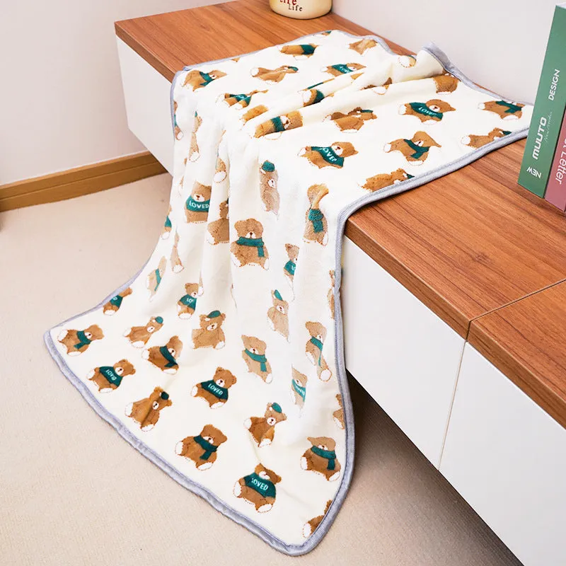 Soft warm pet blanket in pink for dogs and cats, size M, on a pet bed