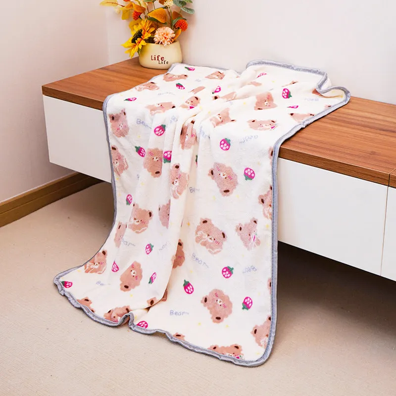 Soft warm pet blanket in pink for dogs and cats, size M, on a pet bed