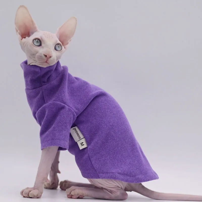 Hairless cat wearing a polar fleece hoodie in autumn winter colours black gray green purple with hood up
