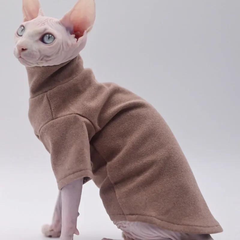 Hairless cat wearing a polar fleece hoodie in autumn winter colours black gray green purple with hood up
