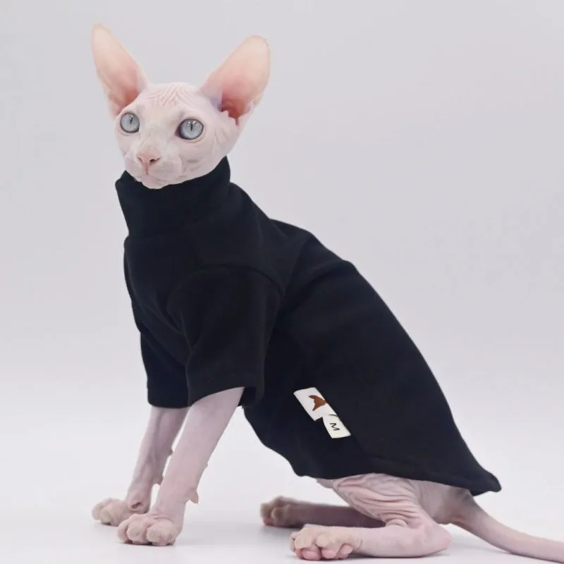 Hairless cat wearing a polar fleece hoodie in autumn winter colours black gray green purple with hood up