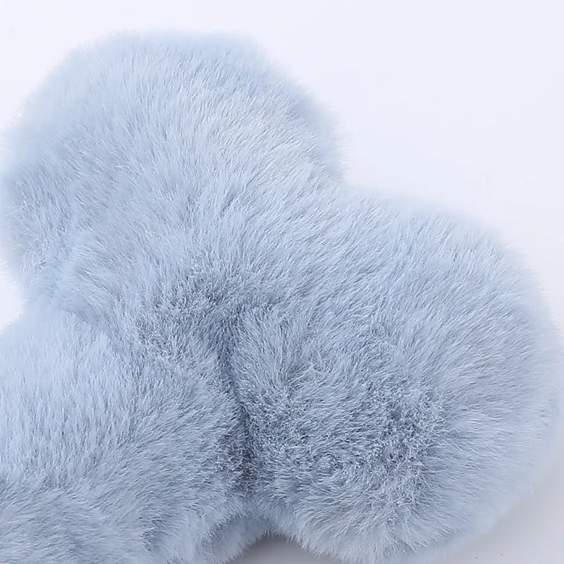 Blue bone-shaped plush dog toy with squeaker and grinding teeth texture for interactive play