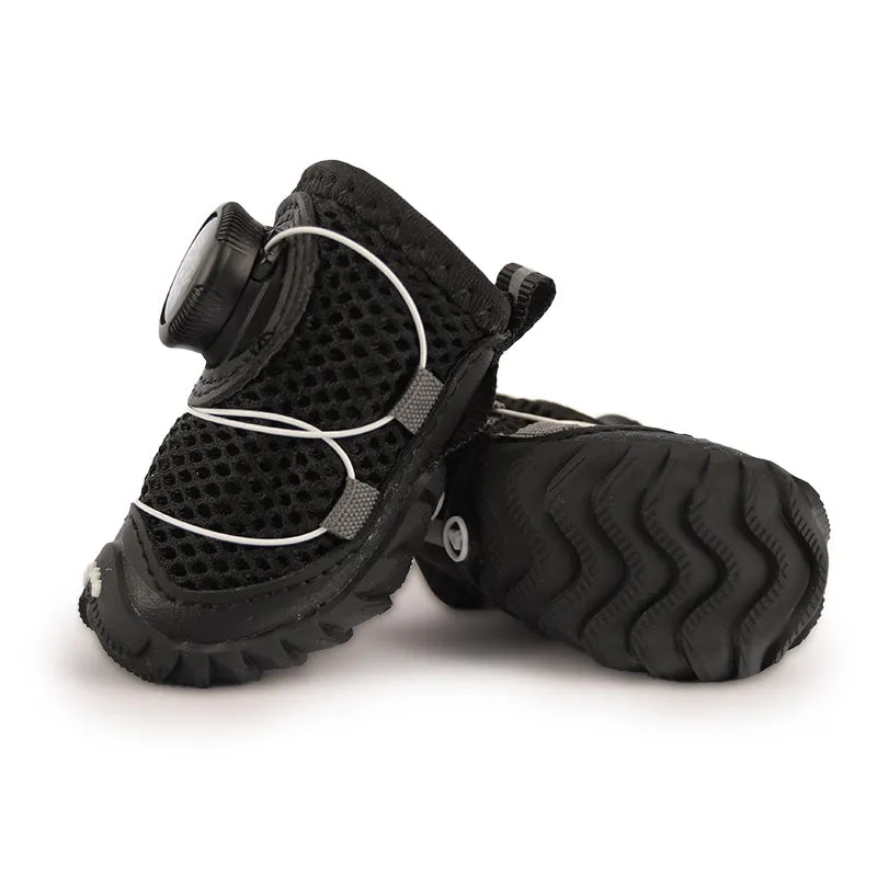 Soft bottom non-slip dog shoes in black with Oxford cloth upper, shown on a small dog