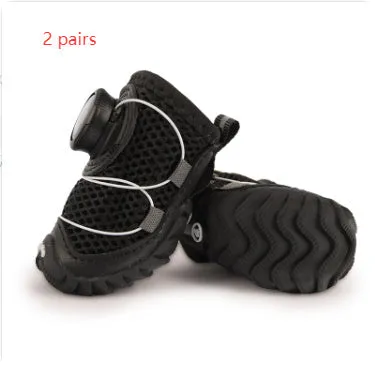 Soft bottom non-slip dog shoes in black with Oxford cloth upper, shown on a small dog