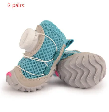 Soft bottom non-slip dog shoes in black with Oxford cloth upper, shown on a small dog
