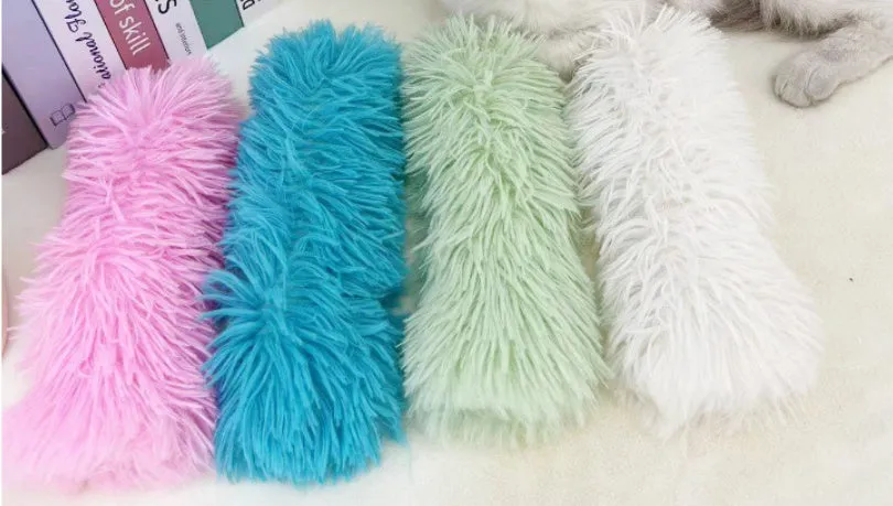 Plush cat toy pillow in blue, green, pink, and white colours, shown at 27cm by 10cm size