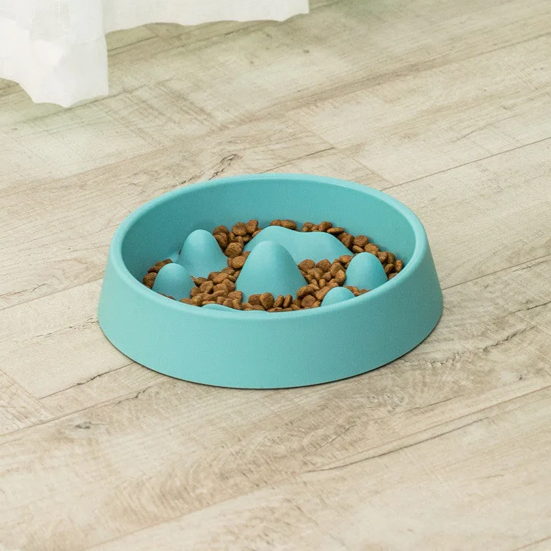 Pet slow food bowl with raised mountain bumps in off-white colour on a floor mat