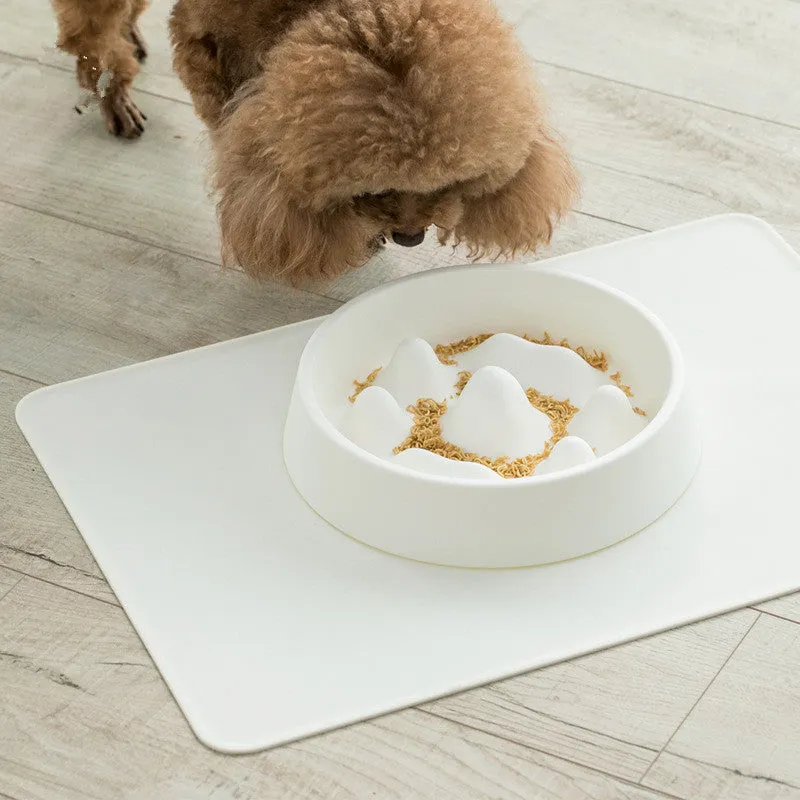 Pet slow food bowl with raised mountain bumps in off-white colour on a floor mat