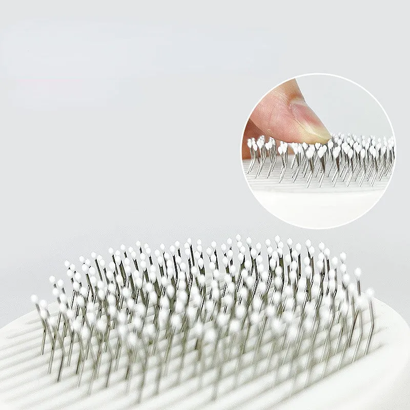 Self-cleaning pet grooming brush with stainless steel bristles and round massage beads for dogs and cats